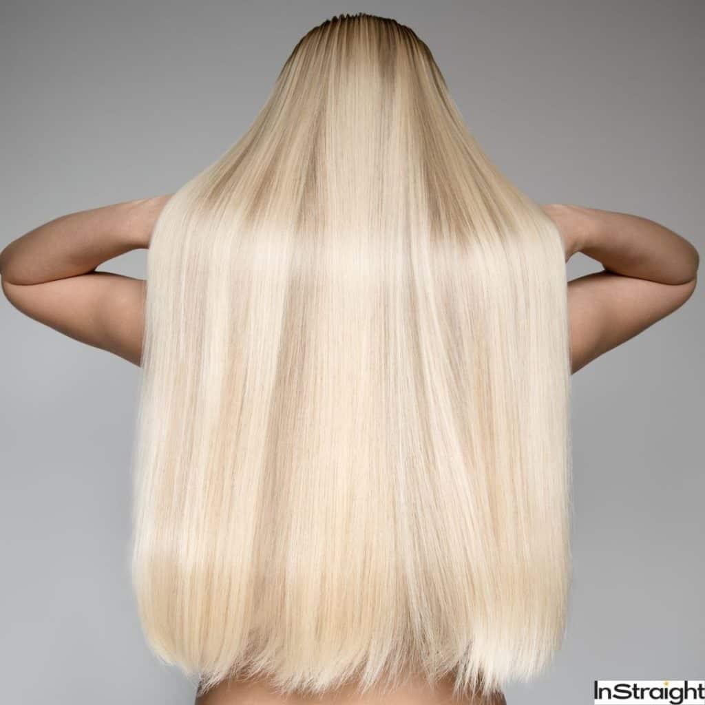 Blonde Woman with straight and shiny hair, the hottest 2022 hair trend.